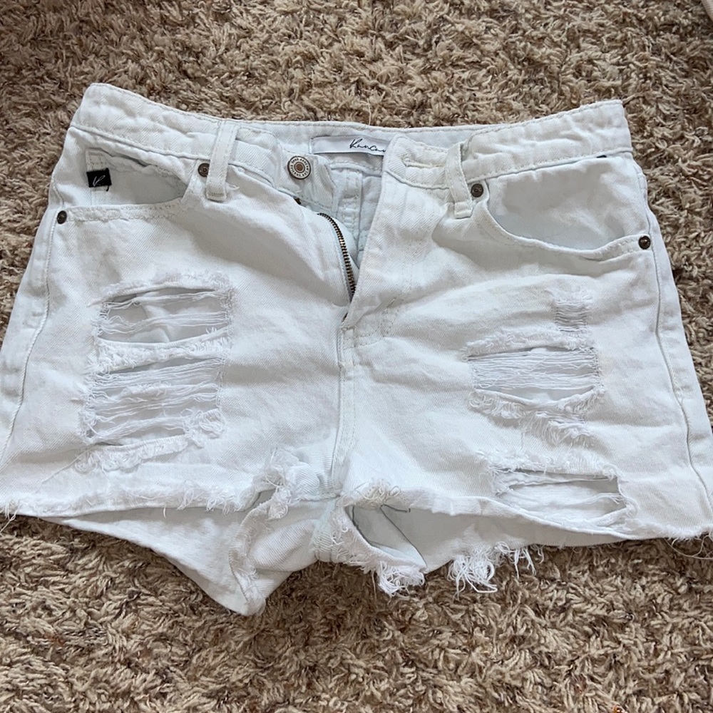 Distressed white jean shorts